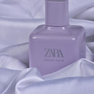 Lavender perfume bottle displayed on luxurious satin sheets, exuding elegance and style.