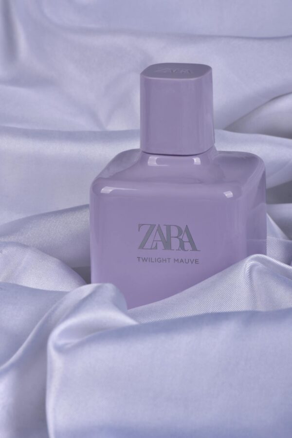 Lavender perfume bottle displayed on luxurious satin sheets, exuding elegance and style.